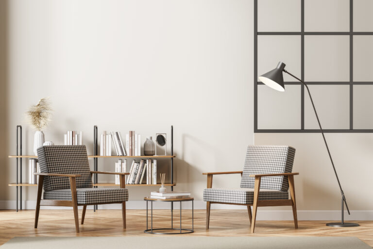 Modern living room interior with two vintage armchairs and coffee table with lamp, bookshelf with books, minimalist reading room on wooden floor. 3D rendering